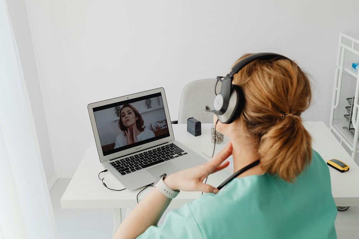 A physical therapist speaks to a patient over video. 